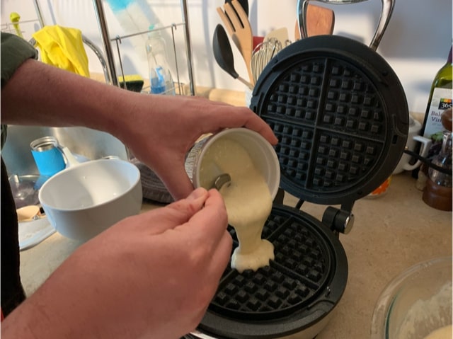 Pouring waffle batter made with sourdough starter discard