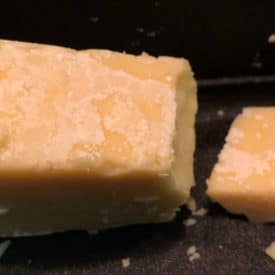 The white crust on this aged cheddar might appear to be mold at first glance, but it's actually calcium lactate crystals, which are safe to eat.