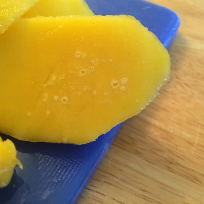 You can eat a mango with little white circles inside