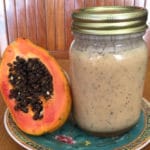 Salad dressing made with papaya sees next to half of a papaya