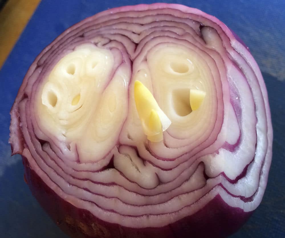 Little sprouts in a red onion