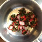 Strawberry tops gathered for sauce