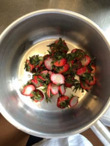 Strawberry tops gathered for sauce